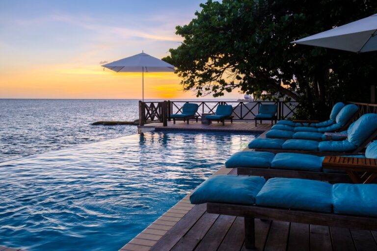 sunset-by-a-swimming-pool-during-a-vacation-in-cur-2023-11-27-05-24-20-utc (1)